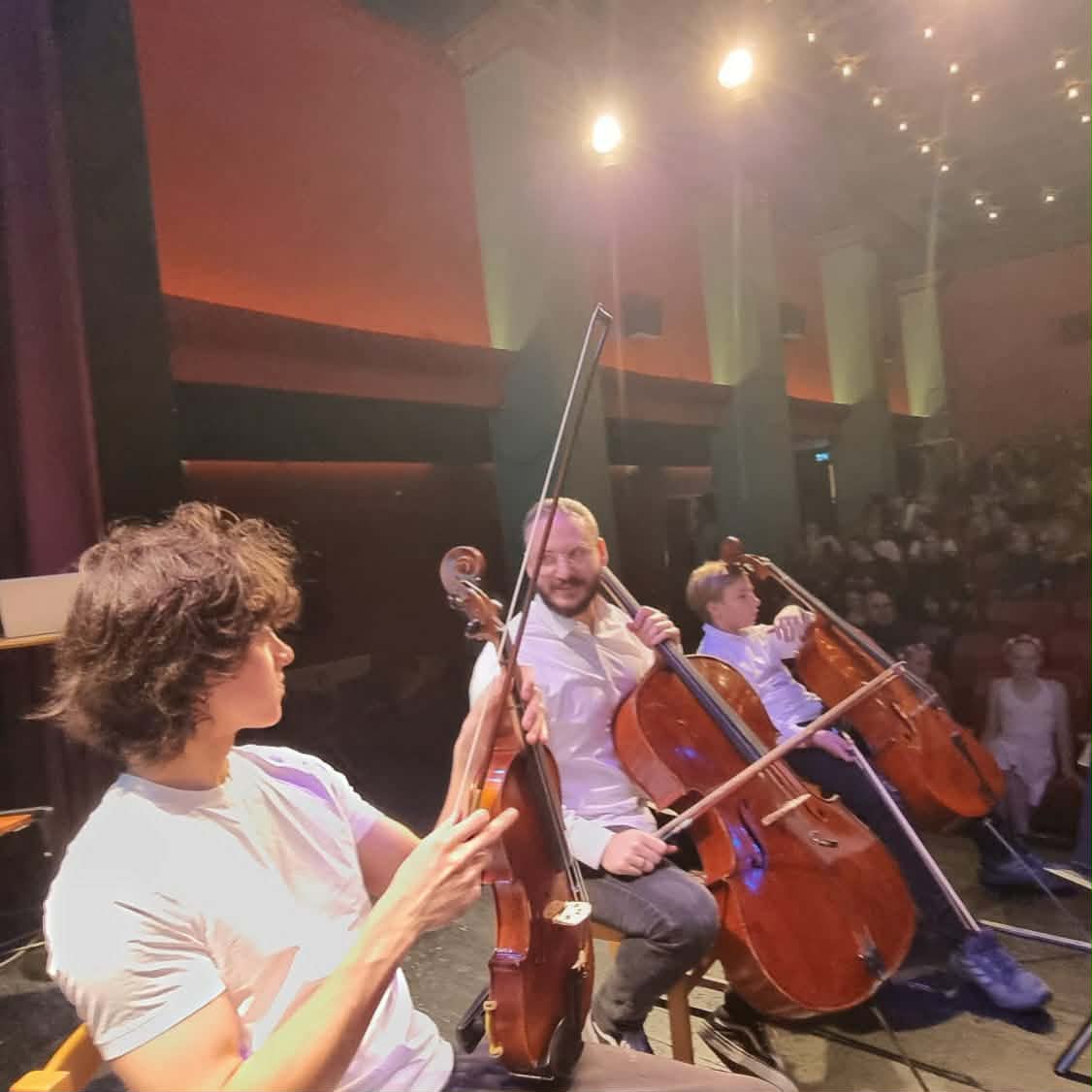 Musiker med fiol och celli på scen under en konsert